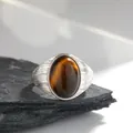 Close-up of vintage S925 sterling silver ring featuring a large oval tiger eye gemstone - Natural Tiger Eye (Silver) / Open Adjustable