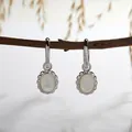 Detail of S925 sterling silver hoop earrings with elegant white mother-of-pearl oval inlays - Natural Mother of Pearl Earrings / Silver