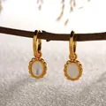 Close-up of S925 sterling silver gold-plated earrings with white mother-of-pearl charms - Natural Mother of Pearl Earrings / Gold