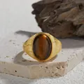 Close-up of vintage gold-plated silver ring featuring a large oval natural tiger's eye stone - Natural Tiger Eye (Gold) / Open Adjustable