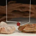 Close-up detail of S925 silver geometric bar pendant necklace with red agate bead - Natural Red Agate / Silver