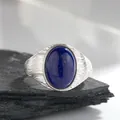 Detailed macro view of an oval lapis lazuli stone on an S925 silver wavy ring band - Natural Lapis Lazuli (Silver) / Open Adjustable