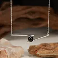 Detailed view of S925 silver necklace featuring a black agate bead on a geometric bar - Natural Black Agate / Silver