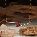 Exquisite close-up of a S925 silver gold-plated geometric bar necklace with red agate bead - Natural Red Agate / Gold
