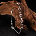 Close-up of S925 sterling silver garnet bracelet displayed on natural wood texture. - Bezel Design / Garnet Red