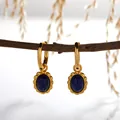 Detailed view of S925 sterling silver earrings with oval natural lapis lazuli pendants. - Natural Lapis Lazuli Earrings / Gold