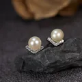 Detailed view of S925 sterling silver V-shaped stud earrings featuring elegant white pearls - Stud Earrings / Natural Freshwater Pearl Stud Earrings Silver