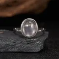 Detailed view of an oval semi-transparent gemstone ring in S925 silver on a stone - Open Size (LR324-1) / Rose Quartz