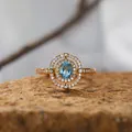 Nahaufnahme eines eleganten S925 Ringes mit blauem Topas und Diamant-Halo-Verzierung - Natürlicher Topas Ring / Gold