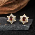Detailed macro view of S925 sterling silver star-shaped earrings with red garnet - Natural Garnet (LN375) / Stud Earrings