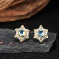 Close-up of star-shaped silver earrings with natural blue topaz and clear gems - Natural Topaz (LN375) / Stud Earrings