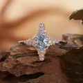 Macro detail of a S925 sterling silver four-point star ring with an oval blue gemstone - Four-pointed Star Style (R421) / Natural Topaz
