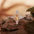 Macro view of a S925 silver four-pointed star ring with a yellow oval gemstone center. - Four-pointed Star Style (R421) / Natural Yellow Citrine