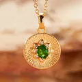 Close-up of gold pendant necklace with green gemstone and radiant sunburst texture - Natural Diopside (Gold)
