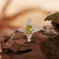 Detailed macro view of a natural peridot ring in an S925 silver four-pointed star setting. - Four-pointed Star Style (R421) / Natural Peridot