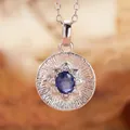 Macro detail of a sterling silver pendant featuring a deep blue tanzanite gemstone. - Natural Sapphire (Silver)