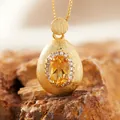 Close-up of elegant citrine gemstone pendant with brushed gold finish on natural rock. - Natural Yellow Quartz Ring Gold
