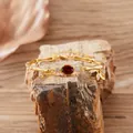 Detail view of gold-plated bamboo link bracelet with oval red garnet - Natural Garnet Bracelet