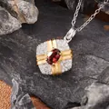 Detailed macro view of a gift-box shaped silver pendant with a red garnet center - Natural Garnet (N457)