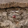 Macro detail of a vintage garnet sun ring in S925 sterling silver on a textured stone background - Open Adjustable / Natural Garnet