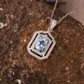 Detailed macro view of an oval blue topaz pendant in S925 silver on textured stone - Natural Topaz (N471)