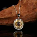 Detail view of a vintage oval garnet pendant with sunburst gold plating and clear stones. - Black Opal (LN265)