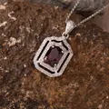 Macro shot of a vintage geometric S925 silver pendant necklace with red gemstone - Natural Garnet (N471)