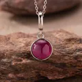 Detail view of a 925 sterling silver necklace featuring a round magenta agate pendant - Natural Red Corundum Style (N470) / Silver