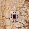 Macro view of S925 silver necklace with emerald-cut red garnet and brushed feather detail - Garnet (N490) / Natural Garnet Necklace