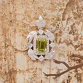Detailed macro shot of S925 sterling silver feather pendant with emerald cut green gemstone - Peridot (N490) / Natural Peridot Necklace