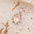 Close-up view of an S925 sterling silver necklace featuring an oval pink gemstone pendant. - European Retro Style (N502) / Natural Rose Quartz (Silver)