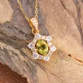Macro view of gold-plated S925 silver sunflower pendant with oval green garnet stone - Natural Peridot Necklace Gold