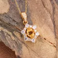 Macro view of sunflower pendant with natural yellow gemstone and sparkling side stones - Natural Citrine Necklace Gold