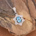 Detailed macro view of an s925 silver sunflower pendant necklace with a blue stone - Natural Topaz Necklace Silver