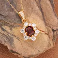 Detailed macro view of a sterling silver sunburst pendant with natural red garnet - Natural Garnet Necklace Gold