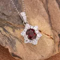 Macro view of sunflower-shaped S925 sterling silver pendant with natural red garnet - Natural Garnet Necklace Silver