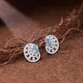 Close-up of vintage S925 silver hollow earrings featuring brilliant blue topaz gems - Natural Topaz Style