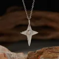 Macro shot of an S925 sterling silver cross pendant with a center natural opal gemstone. - Natural Opal Silver