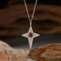 Close-up of S925 sterling silver star pendant necklace with natural red garnet stone. - Natural Garnet Silver