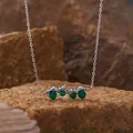 Detail view of S925 silver necklace featuring green agate stones on natural rock background. - Green Agate Necklace / Silver