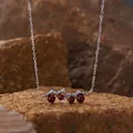 Detail of sterling silver necklace featuring natural garnet stones on rock - Garnet Necklace / Silver