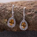 Detailed close-up of teardrop citrine earrings in S925 sterling silver with pave stones - Natural Yellow Citrine