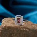 Macro shot of S925 sterling silver ring with rectangular red gem on natural stone base. - Ring / Red (Garnet)