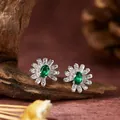 Elegant S925 sterling silver daisy stud earrings featuring oval green gemstones - Stud Earrings / Emerald