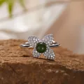Detailed macro view of a silver four-leaf ring featuring green jasper and pave crystals. - Natural Jasper Ring / Silver