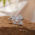 Macro detail view of a sterling silver clover ring with center pearl and paved stones - Natural Freshwater Pearl Ring / Silver
