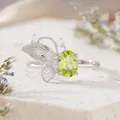 Detailed macro view of an S925 silver butterfly ring featuring a green oval gemstone. - Natural Peridot Ring