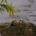 Close-up detail of textured gold earrings featuring natural green agate beads on a rock base. - Green Agate Stud Earrings / Gold