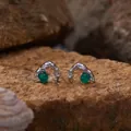 Close-up macro view of silver stud earrings with round green agate stones on rock - Green Agate Stud Earrings / Silver