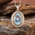 Macro view of oval blue topaz pendant with diamond halo on natural rock surface. - Natural Millennium Cut Topaz Necklace / Blue